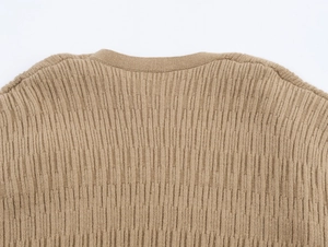 Detail of khaki knit cardigan neckline and fine texture on a white background