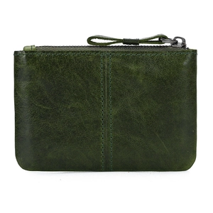 Detail of dark green genuine leather coin purse with clear texture and double stitching