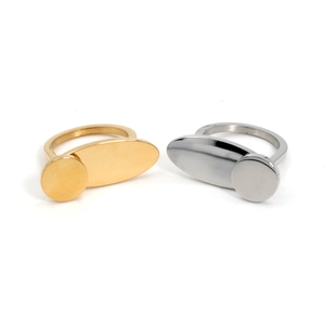Detail view of gold and silver titanium steel rings with oval and circular metal discs