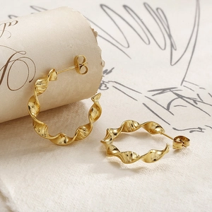 Elegant gold twisted spiral hoop earrings in titanium steel with a vintage French design
