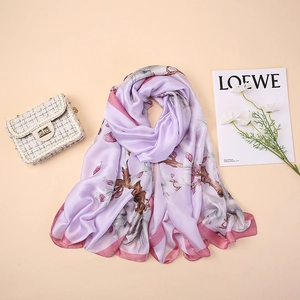 Detail of lavender silk scarf with pink floral prints and pink rolled edges