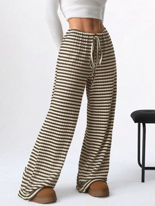 Detail of high waist striped trousers featuring knit texture and adjustable drawstring