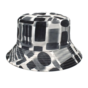 Detail showing the intricate black and white geometric pattern and stitching on a bucket hat