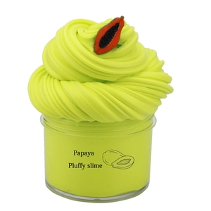 Fluffy lime green slime kit in transparent jar with papaya slice charm and swirl texture