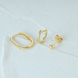 Detailed macro view of S925 sterling silver stamp on gold earrings set surface