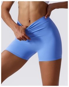 Close-up of the V-shaped cross waist design on light blue stretch yoga shorts