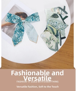 Close-up of floral print silk hair ribbon tied as a bow on a fashion magazine