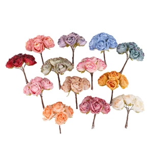 Collection of twelve colorful artificial mini rose bouquets with brown stems for DIY decor