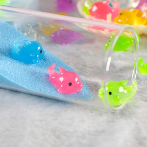 Miniature luminous resin dolphin figurines in assorted colors for desktop decoration