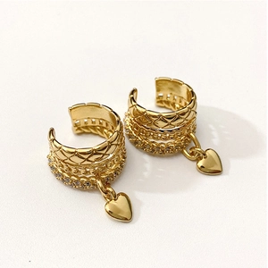 Gold multi-layer ear cuff with quilted patterns, crystals and a heart pendant