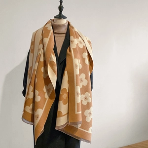Close-up of thick winter floral scarf with tassel fringe on a mannequin