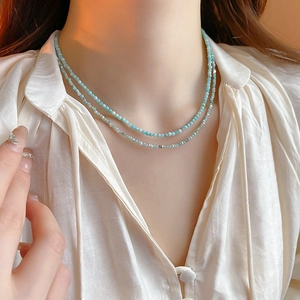 Detail of elegant sky blue beaded double layer necklace on neck with silver accents