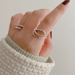 Detail of minimalist S925 sterling silver open rings with elegant curved line design