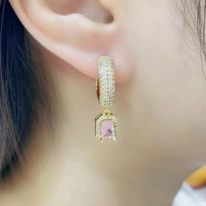 Elegant gold earrings with square pink crystal and micro-paved diamonds on ear lobe