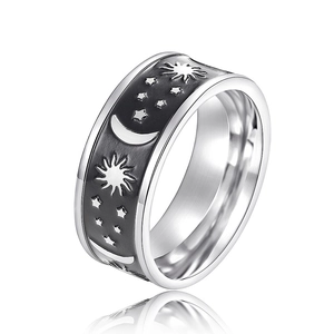 Macro view of wide silver ring band featuring sun moon and star celestial engravings