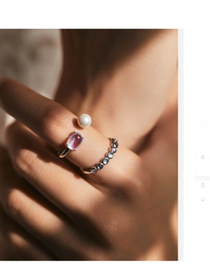 Macro view of S925 silver ring set with white pearl, moonstone and gradient crystals