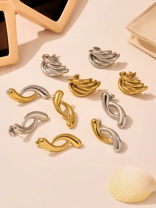 Detailed view of polished 18K gold and silver water drop earrings in various sleek designs