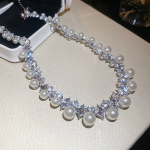 Macro shot of French vintage pearl necklace with sparkling diamond accents and silver luster