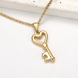 Gold irregular heart key chain necklace with a minimalist aesthetic on white marble