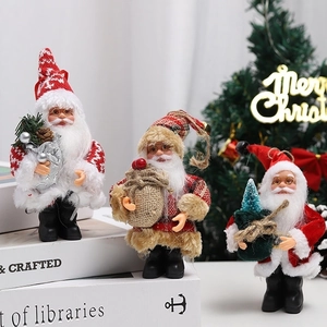 Three plush standing Santa Claus figurines with knit coats and gift bags for Christmas decor