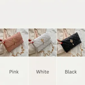 Detail of embroidered small square bags with crown buckle and elegant pearl chain