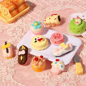 Miniature 11-piece resin cake dessert set for dollhouse and DIY crafts on pink lace