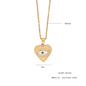 Detail of a heart pendant with evil eye motif, inlaid crystals, and size specifications