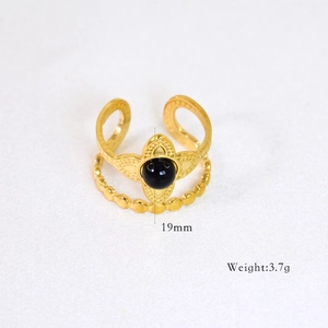 Detail showing 14k gold double-layer ring with black gemstone and beaded band