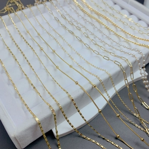 Detail view of 18K gold plated necklace chain styles including snake, bead, and paperclip links