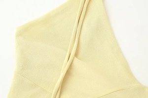 Close-up of yellow knit fabric showing detailed texture on a French vintage midi dress