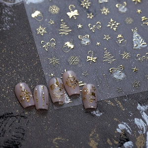 Golden Christmas nail stickers with 3D embossed snowflakes stars and trees for festive art
