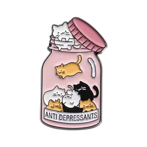 Cute pink glass jar cat enamel pin featuring ANTI DEPRESSANTS text on white background