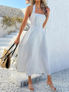 Detail of white halter neck backless maxi dress with a flowing A-line silhouette