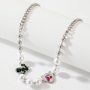 Close-up of Halloween devil and cactus charms on mixed link chain with faux pearls