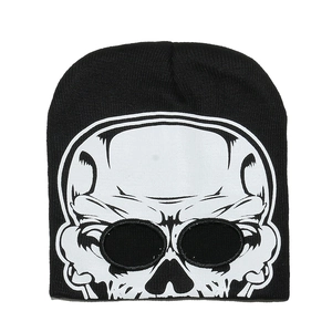 Detail of a black knitted beanie featuring a large white skull print on high-quality fabric