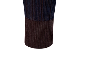 Detailed view of navy blue striped ribbed knit cuffs on a premium men's sweater