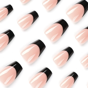 Minimalist glossy nude pink coffin press-on nails with elegant black french tips