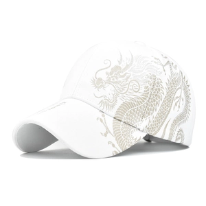 Detail of golden dragon print on the side of a high-quality white cotton baseball cap