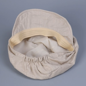 Detail of the elastic sweatband and fine stitching inside this linen newsboy cap