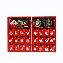 Close-up of a red wooden Christmas advent calendar with 24 numbered drawers and festive art