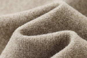 Vista macro del tessuto di lana cammello pesante che mostra texture morbida e fibre fini