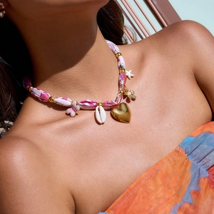 Gold-plated silk scarf necklace with charms of shell, butterfly, and starfish