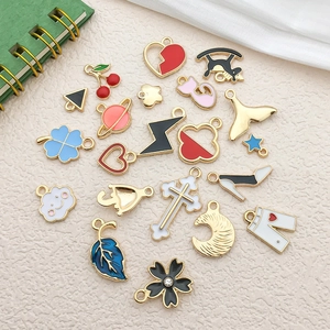 Assorted colorful enamel charms with gold edges including hearts and clovers for DIY jewelry