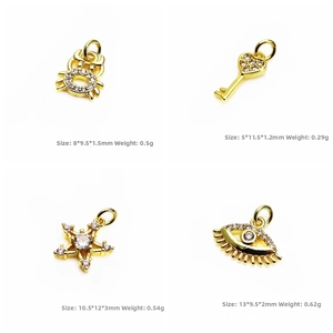 Macro shot of gold zircon charms in star, heart, and eye shapes for jewelry making