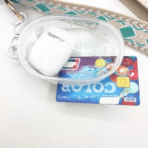 Detail view of transparent PVC oval zipper pouch with beige woven lanyard on white background