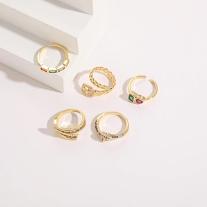 Macro detail of 14K gold plated five-piece ring set with colorful zircon and belt buckle design