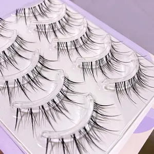 Natural long black faux eyelashes set with clear band in purple packaging tray