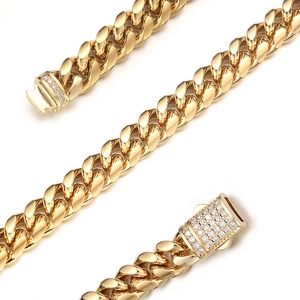 Macro shot of gold-plated Cuban chain link necklace with diamond-encrusted ear buckle