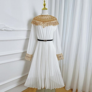 White pleated maxi dress featuring gold sequin lace embroidery and a black waist belt
