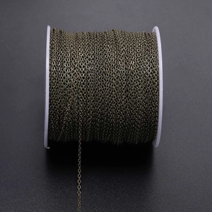 Macro detail of antique bronze plated flattened O-link chain roll for DIY jewelry making